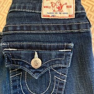 True Religion “Joey” Jeans, lower rise, form fitting, flared at leg opening.